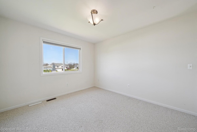 61 Old Carriage Ln, Lapeer, MI 48446 - spare room with light carpet and baseboards