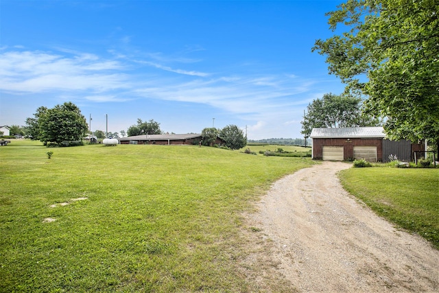 520 Groat Rd, Dowling, MI 49050 - view of green lawn featuring dirt driveway and an outdoor structure