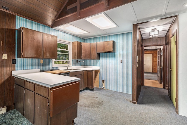 300 Basswood Ter, Brooklyn, MI 49230 - kitchen featuring a peninsula, light countertops, light colored carpet, and wallpapered walls