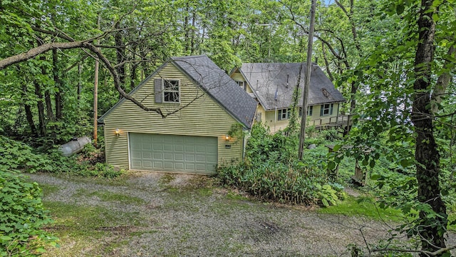 300 Basswood Ter, Brooklyn, MI 49230 - view of front of property featuring a garage and a shingled roof