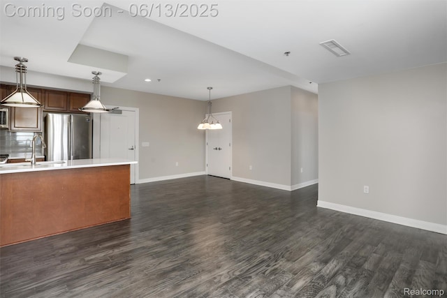 525 W Lafayette Blvd Unit 19C, Detroit, MI 48226 - kitchen featuring freestanding refrigerator, light countertops, dark wood-style floors, recessed lighting, and pendant lighting