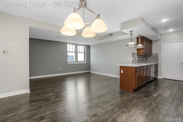 525 W Lafayette Blvd Unit 19C, Detroit, MI 48226 - kitchen with dishwasher, light countertops, dark wood-type flooring, a peninsula, and pendant lighting