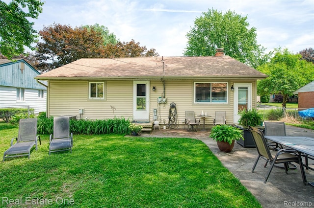 5320 Leland St, Brighton, MI 48116 - back of property featuring a lawn, a chimney, a patio area, and entry steps