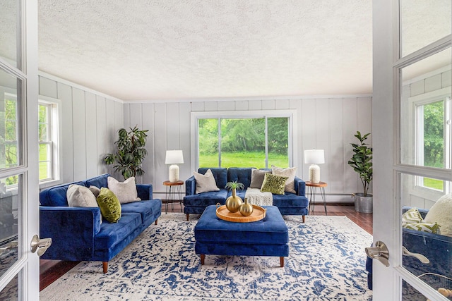 6170 Gregory Rd, Dexter, MI 48130 - living room with wood finished floors, a baseboard radiator, and a textured ceiling
