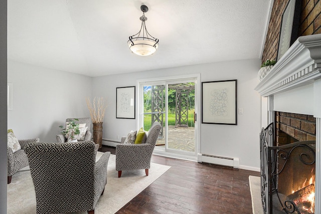 6170 Gregory Rd, Dexter, MI 48130 - living room featuring a baseboard radiator, a fireplace, and dark wood-type flooring