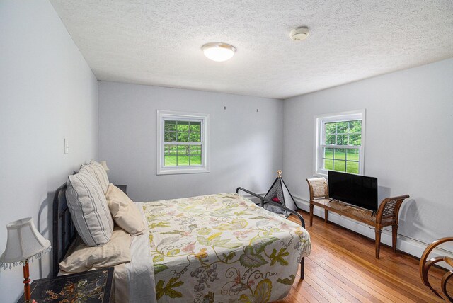 6170 Gregory Rd, Dexter, MI 48130 - bedroom featuring wood-type flooring and a textured ceiling
