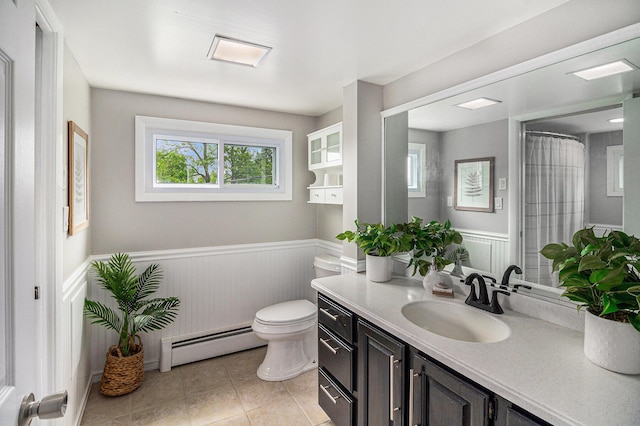 6170 Gregory Rd, Dexter, MI 48130 - bathroom featuring a baseboard heating unit, a wainscoted wall, vanity, and tile patterned floors
