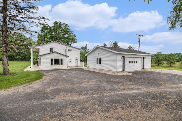 6170 Gregory Rd, Dexter, MI 48130 - view of front of home with an outbuilding, a detached garage, and a front yard