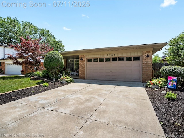 7363 Provincial Rd, Canton, MI 48187 - view of front of house featuring brick siding, driveway, and a garage