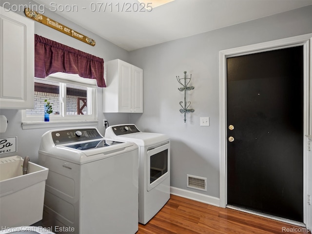 7363 Provincial Rd, Canton, MI 48187 - laundry area featuring cabinet space, independent washer and dryer, and light wood-style floors