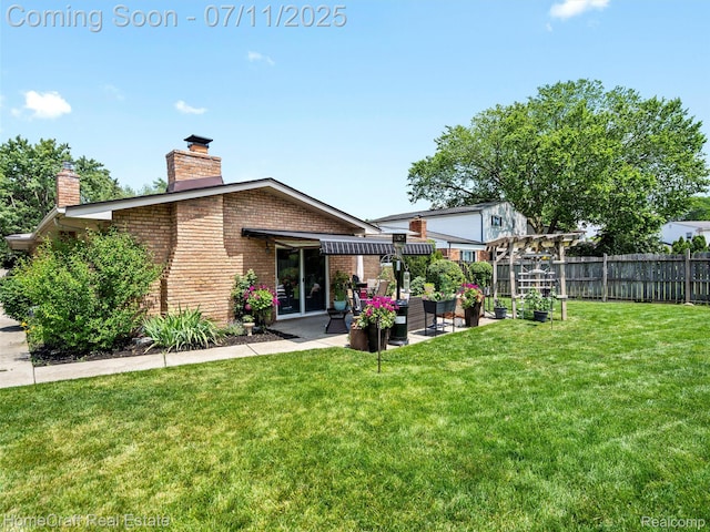 7363 Provincial Rd, Canton, MI 48187 - back of property with brick siding, a chimney, and a patio