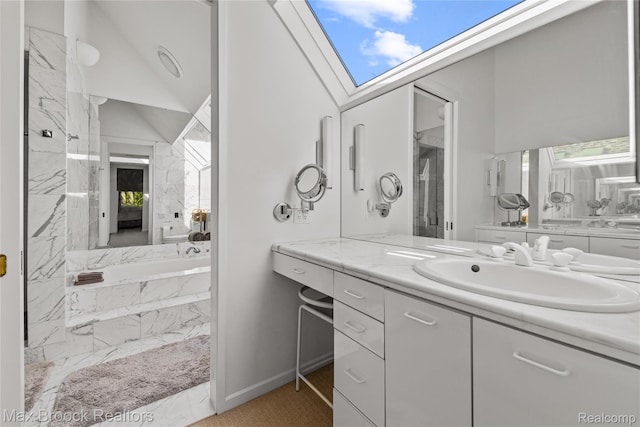 680 Willits St, Birmingham, MI 48009 - bathroom featuring vanity, a tub with marble appearance, a skylight, marble finish flooring, and vaulted ceiling