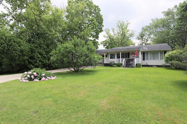 1052 E Rowland St, Grand Blanc, MI 48507 - view of front facade with covered porch, a front yard, and a chimney