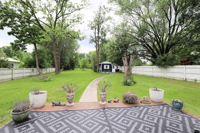 1052 E Rowland St, Grand Blanc, MI 48507 - fenced backyard with an outdoor structure, a wooden deck, and a patio