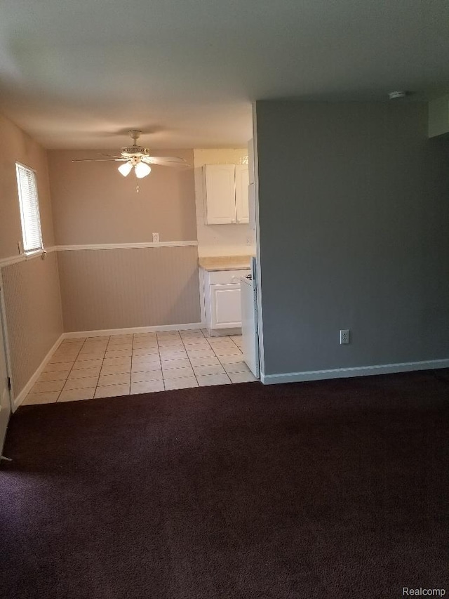 203 W Columbia Ave, Troy, MI 48340 - unfurnished living room featuring ceiling fan, light tile patterned floors, and light colored carpet