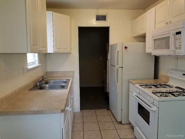 203 W Columbia Ave, Troy, MI 48340 - kitchen with white appliances, white cabinetry, tasteful backsplash, light countertops, and light tile patterned floors