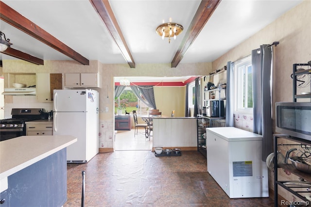 927 Piper Dr, Saginaw, MI 48604 - kitchen with appliances with stainless steel finishes, under cabinet range hood, light countertops, beamed ceiling, and decorative backsplash