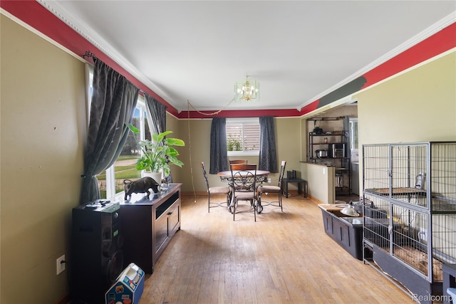 927 Piper Dr, Saginaw, MI 48604 - dining area with wood finished floors, a chandelier, and ornamental molding