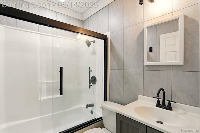 2121 Chesley Dr, Sterling Heights, MI 48310 - full bathroom with tile walls, shower / bath combination with glass door, and vanity