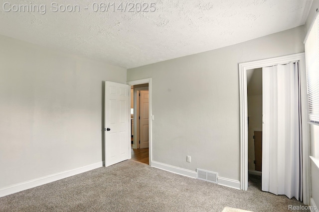2121 Chesley Dr, Sterling Heights, MI 48310 - unfurnished bedroom with carpet floors and a textured ceiling