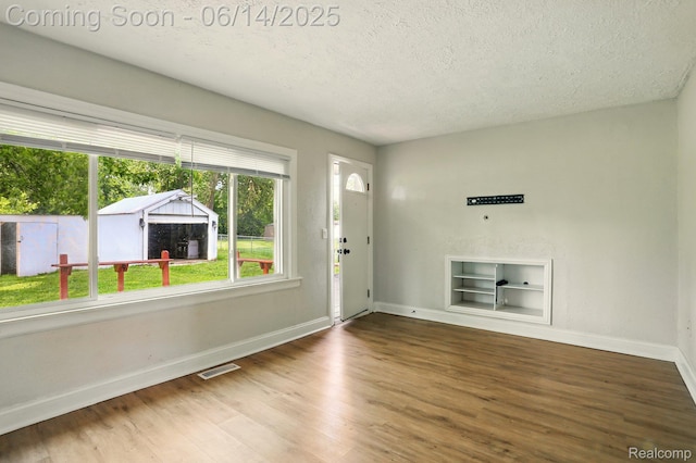 2121 Chesley Dr, Sterling Heights, MI 48310 - foyer featuring a textured ceiling and wood finished floors