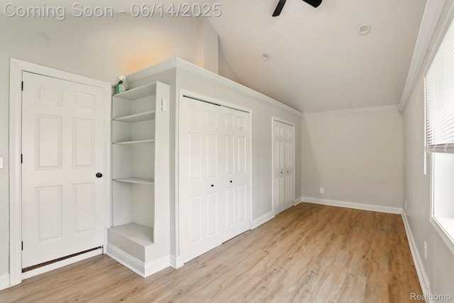 2121 Chesley Dr, Sterling Heights, MI 48310 - unfurnished bedroom with light wood-style flooring, multiple closets, ornamental molding, lofted ceiling, and ceiling fan