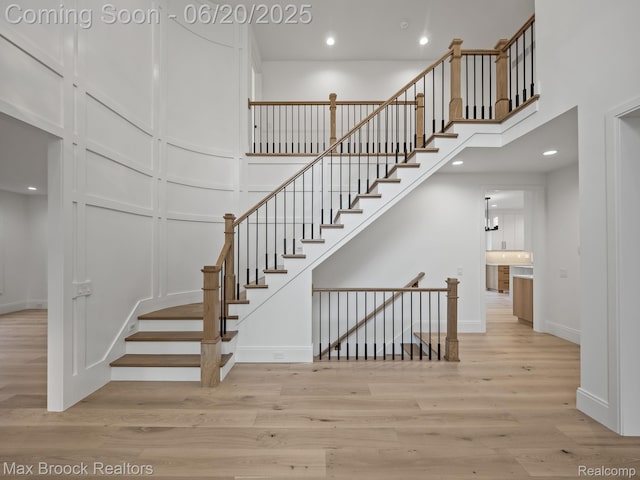 4331 Spruce Hill Ln, Birmingham, MI 48301 - stairway with wood finished floors, recessed lighting, and a towering ceiling
