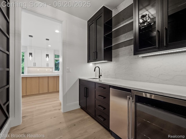 4331 Spruce Hill Ln, Birmingham, MI 48301 - bar area featuring wine cooler, light wood-style floors, decorative backsplash, refrigerator, and decorative light fixtures