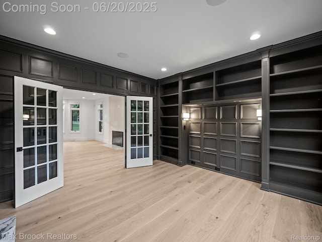 4331 Spruce Hill Ln, Birmingham, MI 48301 - unfurnished room with a decorative wall, french doors, recessed lighting, and light wood-style floors