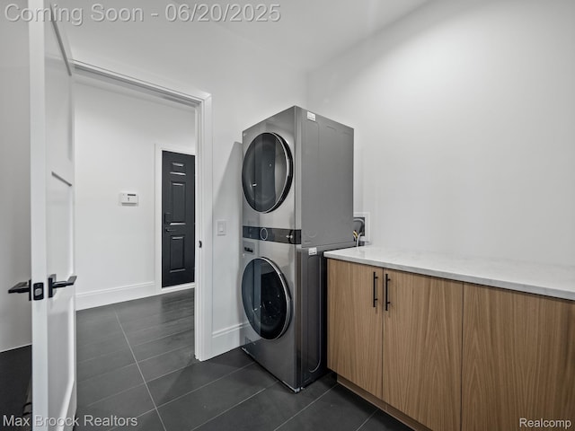 4331 Spruce Hill Ln, Birmingham, MI 48301 - laundry room with estacked washer and dryer and dark tile patterned floors