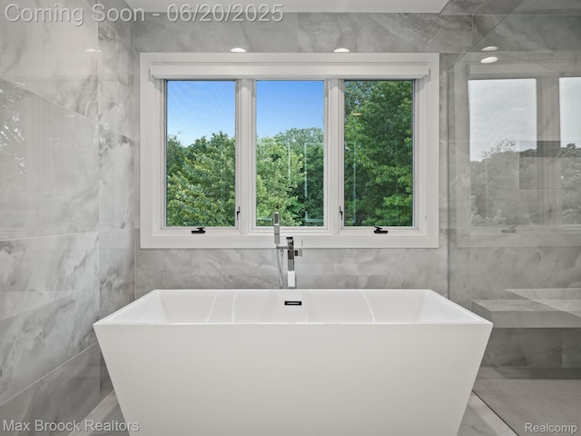 4331 Spruce Hill Ln, Birmingham, MI 48301 - bathroom with tile walls and a freestanding tub