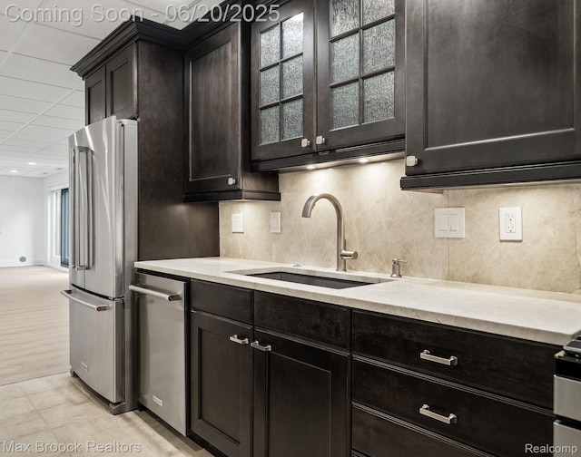 4331 Spruce Hill Ln, Birmingham, MI 48301 - kitchen featuring appliances with stainless steel finishes, tasteful backsplash, and glass insert cabinets