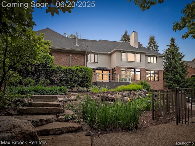 4331 Spruce Hill Ln, Birmingham, MI 48301 - back of property featuring a chimney, brick siding, stucco siding, and a shingled roof