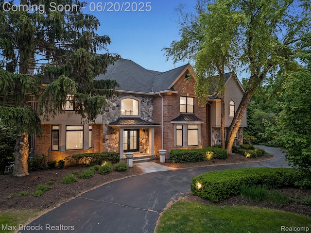 4331 Spruce Hill Ln, Birmingham, MI 48301 - view of front of house with stone siding, asphalt driveway, and a standing seam roof
