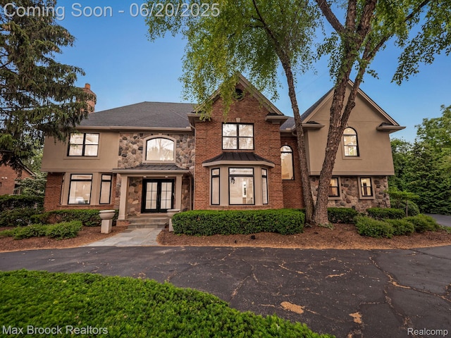 4331 Spruce Hill Ln, Birmingham, MI 48301 - view of front facade with stone siding, stucco siding, french doors, and a chimney