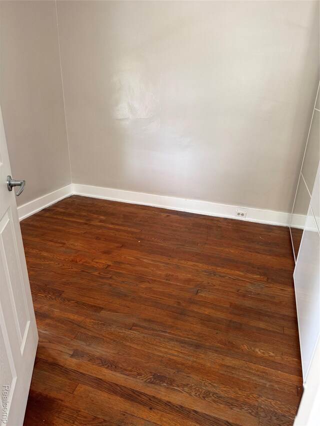 7821 Mead St, Dearborn, MI 48126 - empty room with dark wood-style floors and baseboards