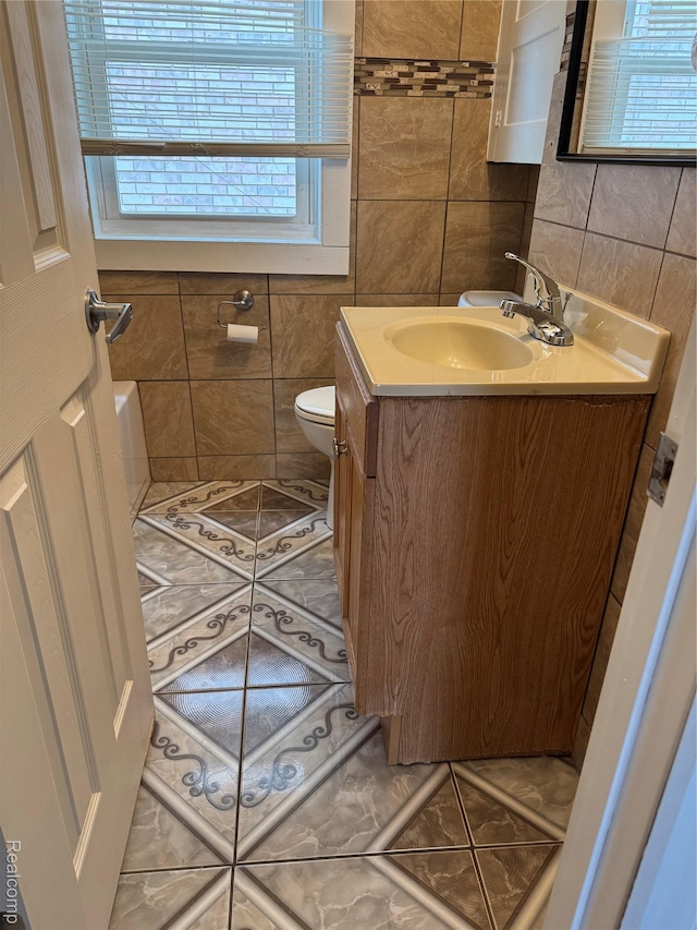 7821 Mead St, Dearborn, MI 48126 - bathroom with tile walls, vanity, and tile patterned flooring