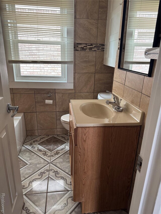 7821 Mead St, Dearborn, MI 48126 - full bathroom featuring tile walls, vanity, a tub to relax in, and plenty of natural light