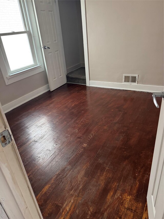 7821 Mead St, Dearborn, MI 48126 - empty room with dark wood-style flooring and baseboards
