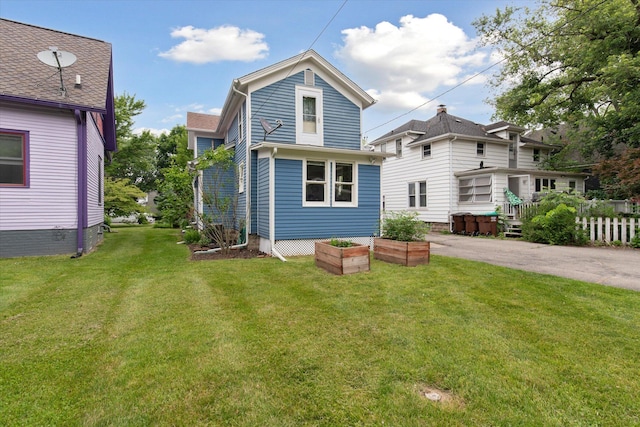 238 E E Main St, Milan, MI 48160 - back of house featuring a yard