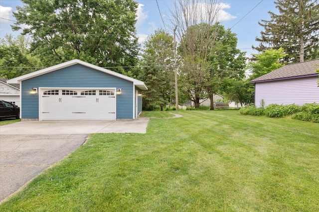 238 E E Main St, Milan, MI 48160 - view of grassy yard featuring a detached garage and an outbuilding