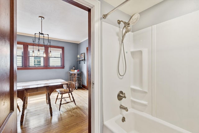 238 E E Main St, Milan, MI 48160 - full bathroom featuring wood finished floors, tub / shower combination, and ornamental molding