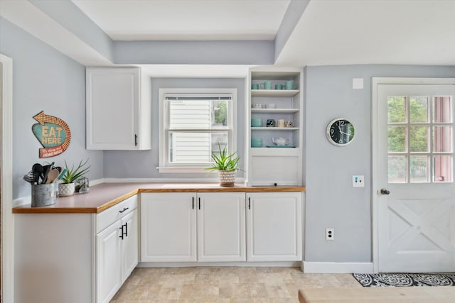 238 E E Main St, Milan, MI 48160 - kitchen with white cabinets, plenty of natural light, light countertops, and open shelves