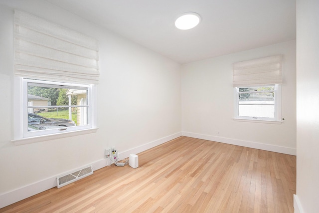 1102 Spencer St NE, Grand Rapids, MI 49505 - unfurnished room featuring light wood-style flooring and plenty of natural light