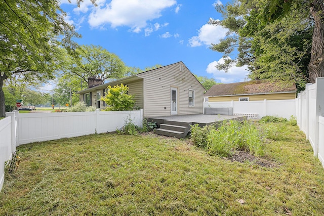 1102 Spencer St NE, Grand Rapids, MI 49505 - back of property with a deck, a fenced backyard, and a chimney