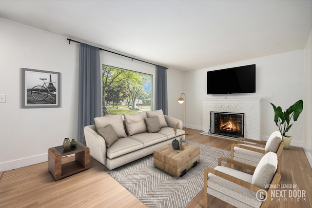 1102 Spencer St NE, Grand Rapids, MI 49505 - living area featuring a brick fireplace and wood finished floors
