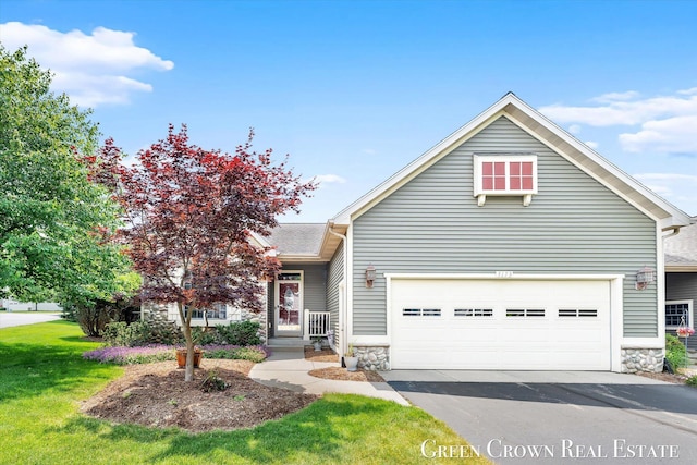 5173 Olsen Springs Ct Unit 13, Wyoming, MI 49509 - view of front of house with stone siding, asphalt driveway, a front lawn, and an attached garage