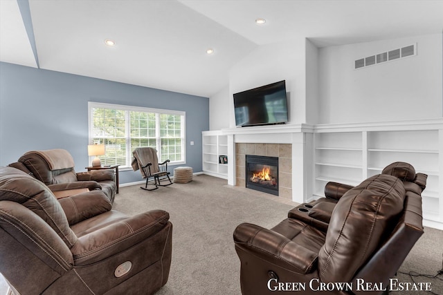 5173 Olsen Springs Ct Unit 13, Wyoming, MI 49509 - carpeted living room with vaulted ceiling, a tiled fireplace, and recessed lighting