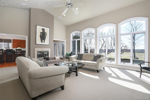5007 Rockaway Ln, Clarkston, MI 48348 - living area with carpet floors, a ceiling fan, a glass covered fireplace, and high vaulted ceiling