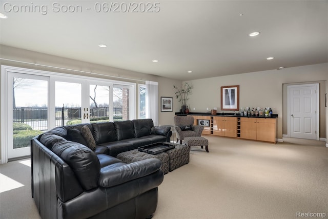 5007 Rockaway Ln, Clarkston, MI 48348 - living area with light carpet, healthy amount of natural light, a bar, and recessed lighting